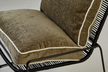 Modern comfortable armchair with green cushions and black metal frame