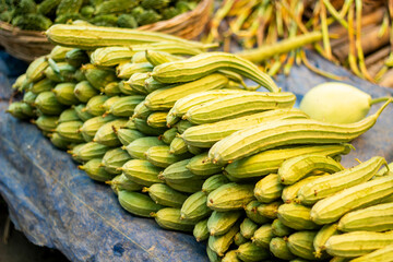 There are many luffas spread out together in the market.