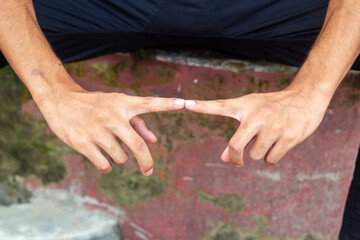 A handsome young man showing style with his fingers.