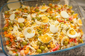 Refreshing salad with olives, tuna, and egg. Homemade Russian salad with classic ingredients.