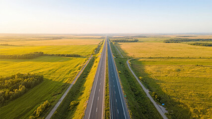 Naklejka premium Aerial View of a Straight Highway Cutting Through Golden Fields