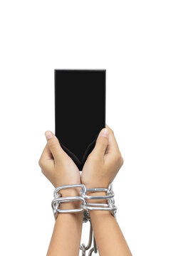 Phone addiction concept. Hand chained to a smartphone symbolizing nomophobia and digital dependency, isolated on white background with clipping path.