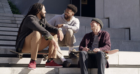 Skateboard, friends and talking with laughing on stairs for funny chat, skating break and bonding. Relax, skater group and men with comic conversation outdoor for practice, sports discussion or happy