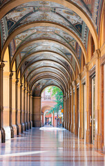 Beautifully decorated portici in Cavour square in Bologna, during a sunny day in the summer.