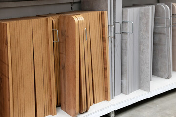 Display of various laminate and wood panel samples in a home improvement store during afternoon hours