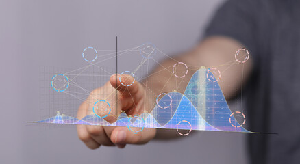 Hand interacting with a futuristic data graph.  Business analytics, technology concept.