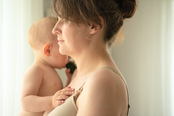 Peaceful home moment of mother embracing her sleeping child with love and care. Heartwarming scene...