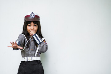 A Girl Confidently playing the role of a junior police officer.
