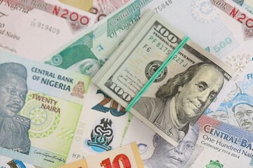 Nigerian naira currency money bills and bunch of us dollar banknotes. The concept of economics and currency exchange