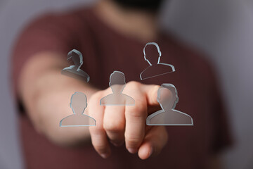 Person interacts with holographic profiles, choosing a team member.  Perfect for teamwork,...