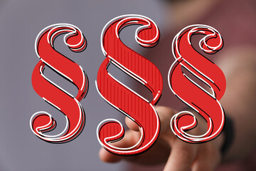 Red paragraph symbols on a blurred background. Ideal for legal, justice, and law concepts.