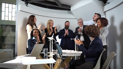 Business team celebrating green energy success during a meeting. Multiracial professionals applauding innovation and sustainability. Renewable energy concept in corporate environment. - Powered by Adobe