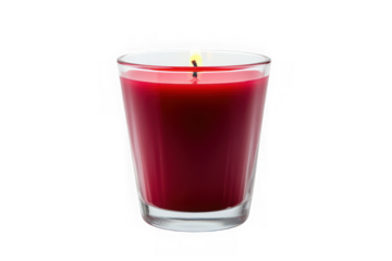 A lit red candle in a clear glass container against a black background