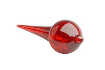 Shiny red glass object with a pointed end on black background