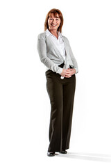 Friendly woman with hands clasped. A smiling businesswoman stands with her hands held in front of her against a white background. © track5