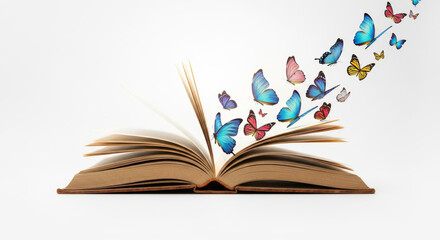 Butterflies flying out of the open pages of a book, isolated on a white background