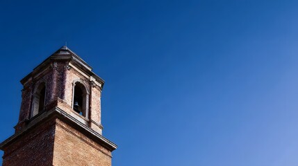 A stately bell tower standing against a clear blue sky