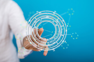 Stock photo of a person interacting with a holographic digital interface showing data and statistics.