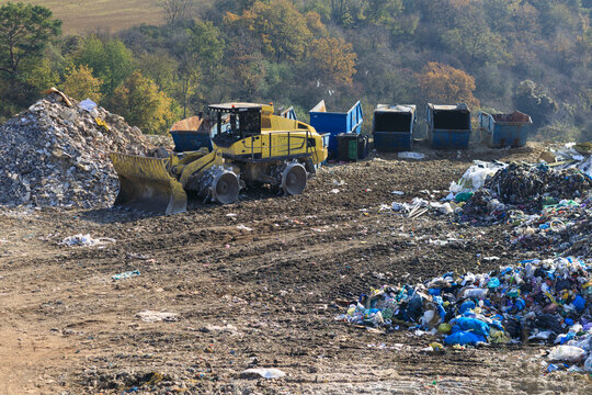 A compactor at a landfill processes sorted waste into containers