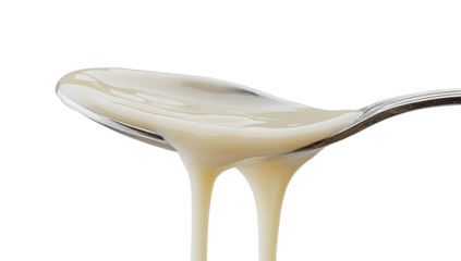 A dollop of creamy mayonnaise or white sauce on a silver spoon, isolated on a clean white background with a soft shadow