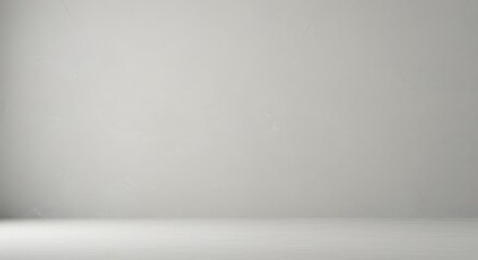 Clean empty studio room with gray wall and floor. Minimalist interior background for product display or presentation.