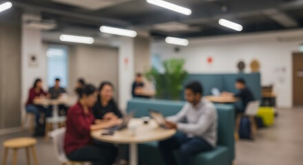 Abstract blurred background of a modern co-working space with diverse colleagues collaborating at a table.