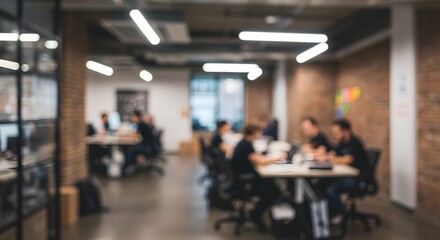 Fototapeta premium Blurred background of a modern coworking space with creative professionals collaborating in a dynamic office environment.