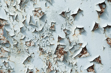 old peeling paint on metal wall close up