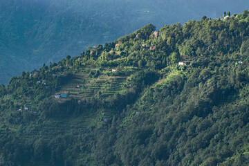 Fototapeta premium Sun rays falling on Himalayan mountain range, scenic beauty of layers of mountains, Okhrey, sikkim, India. Okhrey village a remote place in Sikkim where mountain range view is enjoyed by tourists.