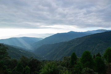 Sun rays falling on Himalayan mountain range, scenic beauty of layers of mountains, Okhrey, sikkim, India. Okhrey village a remote place in Sikkim where mountain range view is enjoyed by tourists.