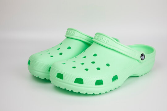 Bangkok, Thailand - August 12, 2018 : A pair of green Crocs sandals with motif design isolated on white background.