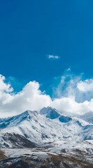 Snow-capped mountain range under a vibrant blue sky.