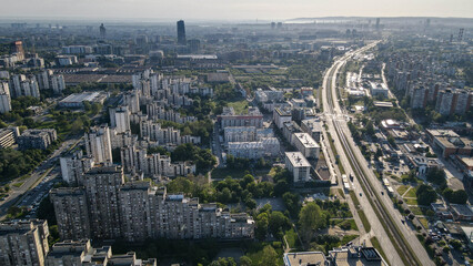 Drone view from a tall building in New Belgrade, Serbia, showing rows of residential blocks glowing...