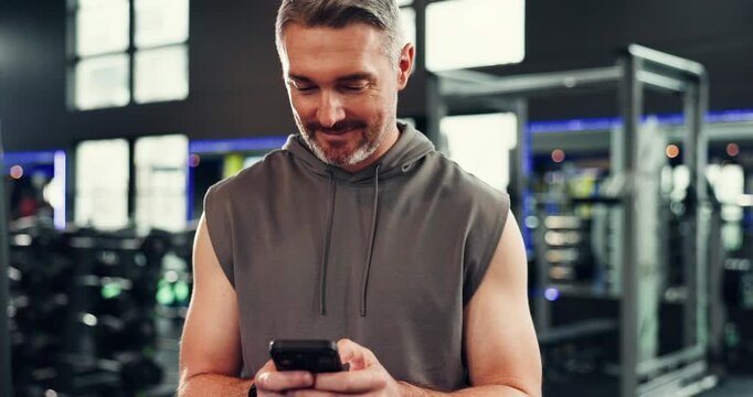 Smile, mature man and phone at gym for social media, fitness app and sign up on web. Happy, male person and mobile for program research, review progress and online notification of sports membership