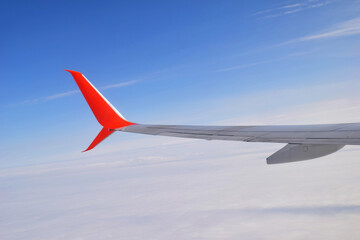Airplane wing on blue sky background