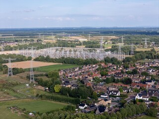 Aerial view of suburb with power lines and substation.
