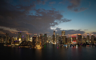 Fototapeta premium Famous landmarks of Miami Brickell from above at night. Drone view of the Brickell in Miami city. Business in Brickell district. Biscayne Bay Florida iconic urban coastline in daylight.