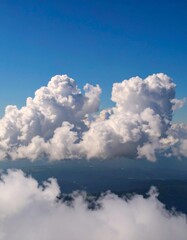Fluffy clouds above misty mountains