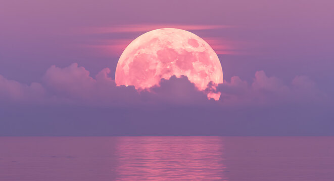 Stunning full pink moon reflecting over serene ocean waters with pastel clouds and sky at twilight