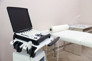 Modern ultrasound machine and examination bed in clinic