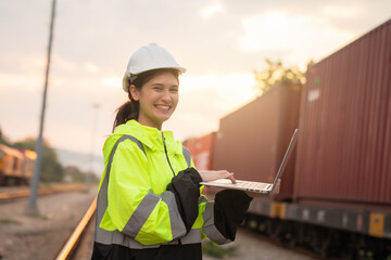 Foreman checking inventory or task details on freight train cars and shipping containers. Logistics...