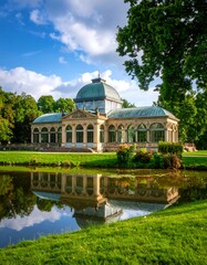 Elegant glasshouse reflecting on a pond