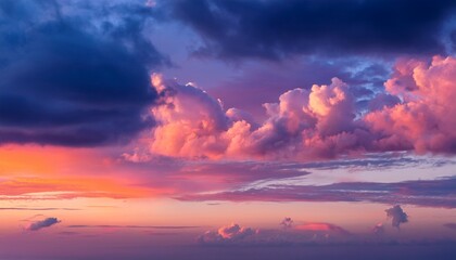 vibrant sunset sky filled with fluffy clouds in shades of pink purple and orange during twilight hours