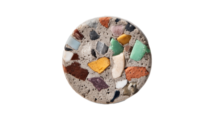 A round terrazzo coaster or material sample with colorful stone chips