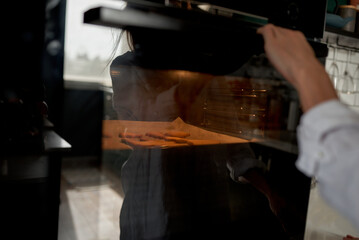 female hands holding a tray with fresh homemade gingerbread