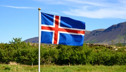 The Icelandic Flag proudly waving in a field with mountain landscape scenery