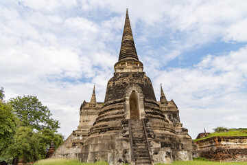 Fototapeta premium Ancient stupa of Wat Phra Si Sanphet in Ayutthaya Historical Park, Thailand under blue sky, showcasing traditional Thai architecture and historical significance
