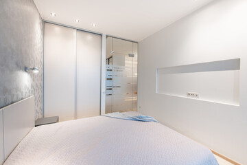 Luxury Home Bedroom Interior. King Size Bed, White Walls and Ceiling