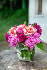 Beautiful bouquet of summer peonies flowers in a glass vase 