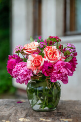 Beautiful bouquet of summer peonies flowers in a glass vase 